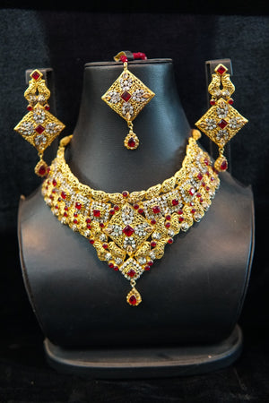 Gold plated set with glass red stones and real zircon stones